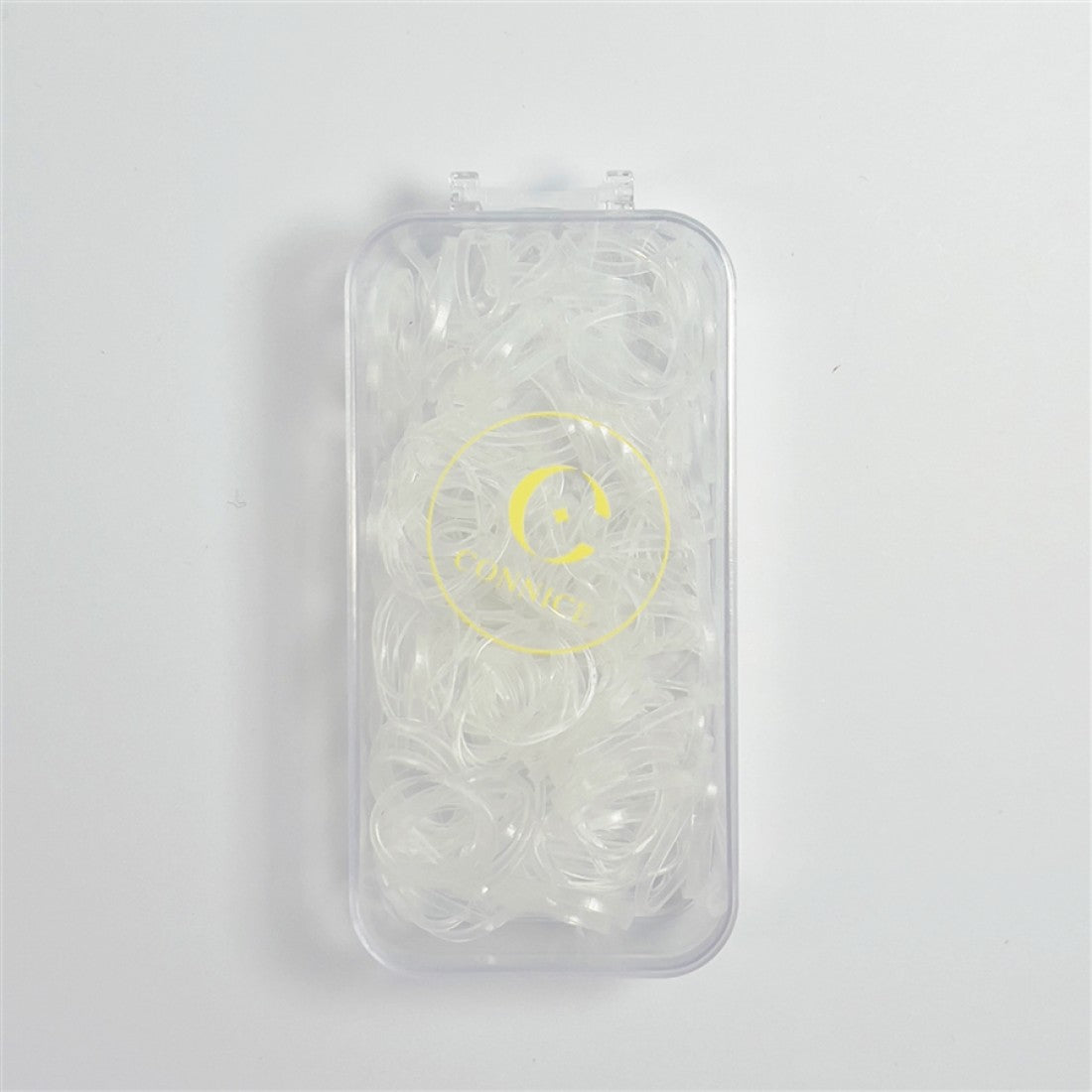 Clear mini hair elastics; Rectangular transparent plastic case; Yellow circular logo print on case; Compact, pocket-sized packaging;
