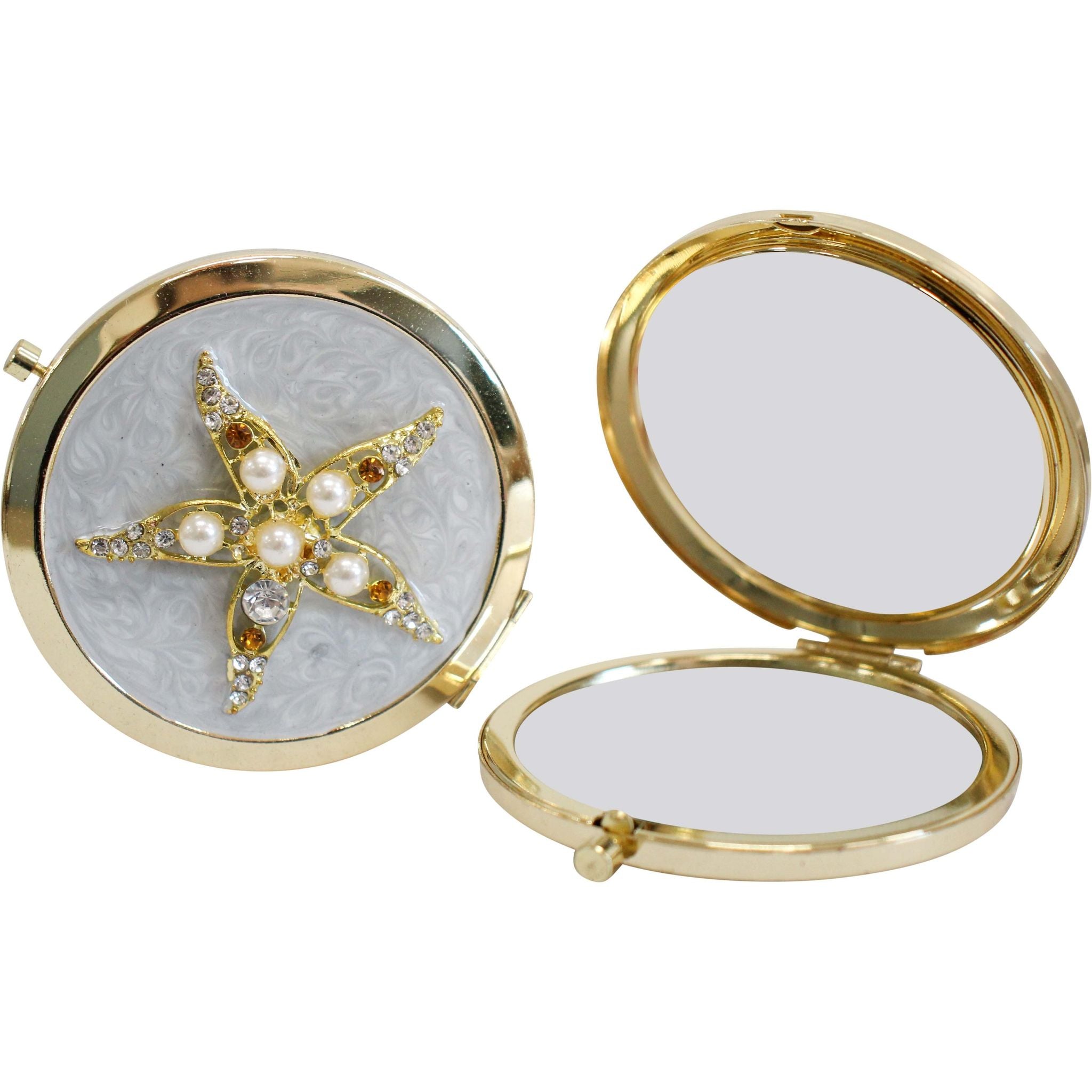 round compact mirror; gold frame; textured light blue lid; decorated with gold starfish embellishment; white pearls and clear rhinestones;