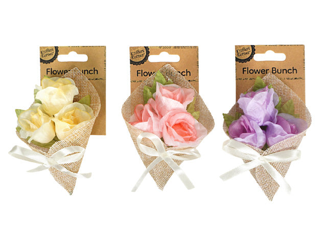 small bunch of artificial flowers; wrapped in natural jute fabric; tied with off-white satin ribbon; available in pale yellow, pink, and purple; green leaves;