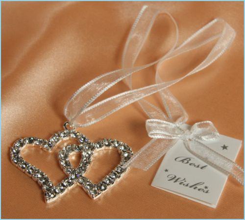 double intertwined heart shapes; decorated with clear rhinestones; attached white organza ribbon; includes small 'Best Wishes' gift tag;