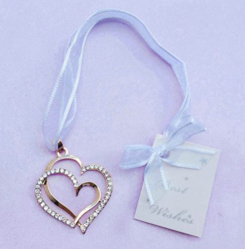 gold-coloured double heart shape; rhinestone embellishments on one heart; white hanging ribbon; attached gift tag with 'Best Wishes'; matte lavender background;