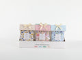 Two fragrance sachets per pack with pastel coloured header cards; Floral patterned sachets with yellow, pink and blue tones; Ribbon bow tied at the top of each sachet pack; Packaged in a white display tray;