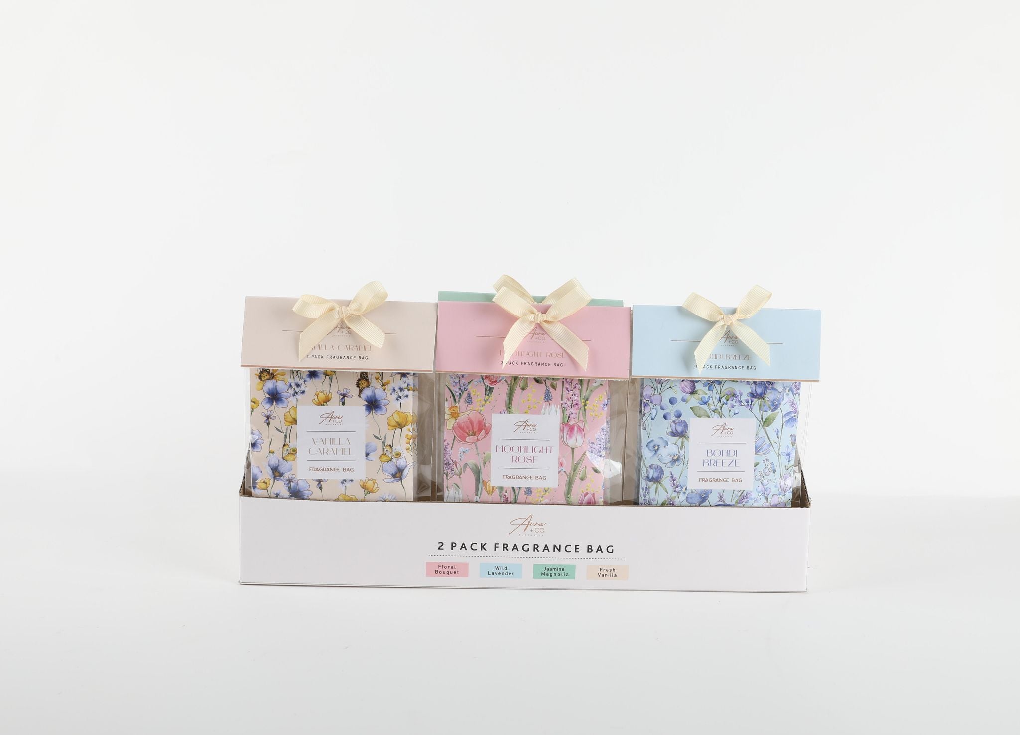 Two fragrance sachets per pack with pastel coloured header cards; Floral patterned sachets with yellow, pink and blue tones; Ribbon bow tied at the top of each sachet pack; Packaged in a white display tray;