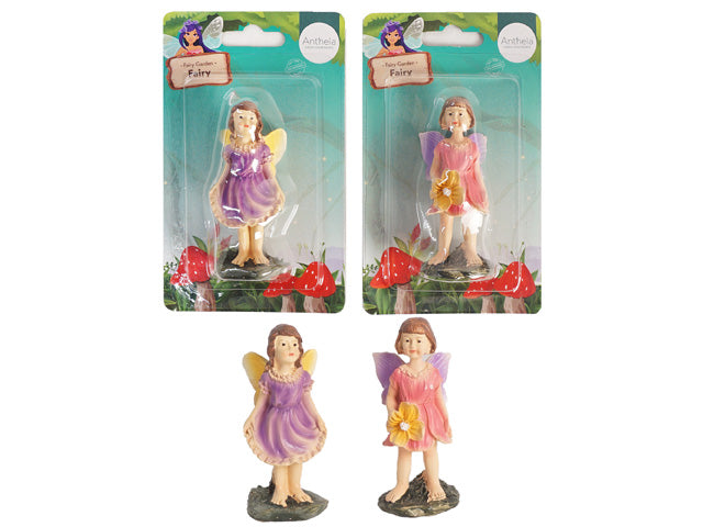fairy figurines in pastel purple and pink dresses; each figurine standing on a textured base mimicking stone; painted fairy wings in yellow and purple shades; packaged in clear plastic blister with garden-themed backing card;