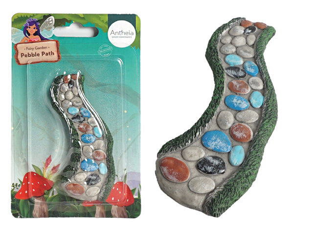 curved pebble path shape; mixed coloured pebbles (white, blue, brown, black); green textured edging resembling grass; plastic blister packaging with branded card backing;