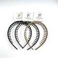 Plastic headband with comb-like teeth along the top; Neutral solid colours including black, dark brown and tan shown; Curved, flexible band shape; Each headband displayed on branded CONNICE card packaging;