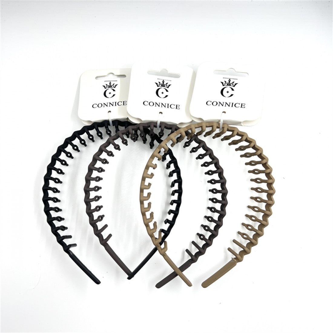 Plastic headband with comb-like teeth along the top; Neutral solid colours including black, dark brown and tan shown; Curved, flexible band shape; Each headband displayed on branded CONNICE card packaging;