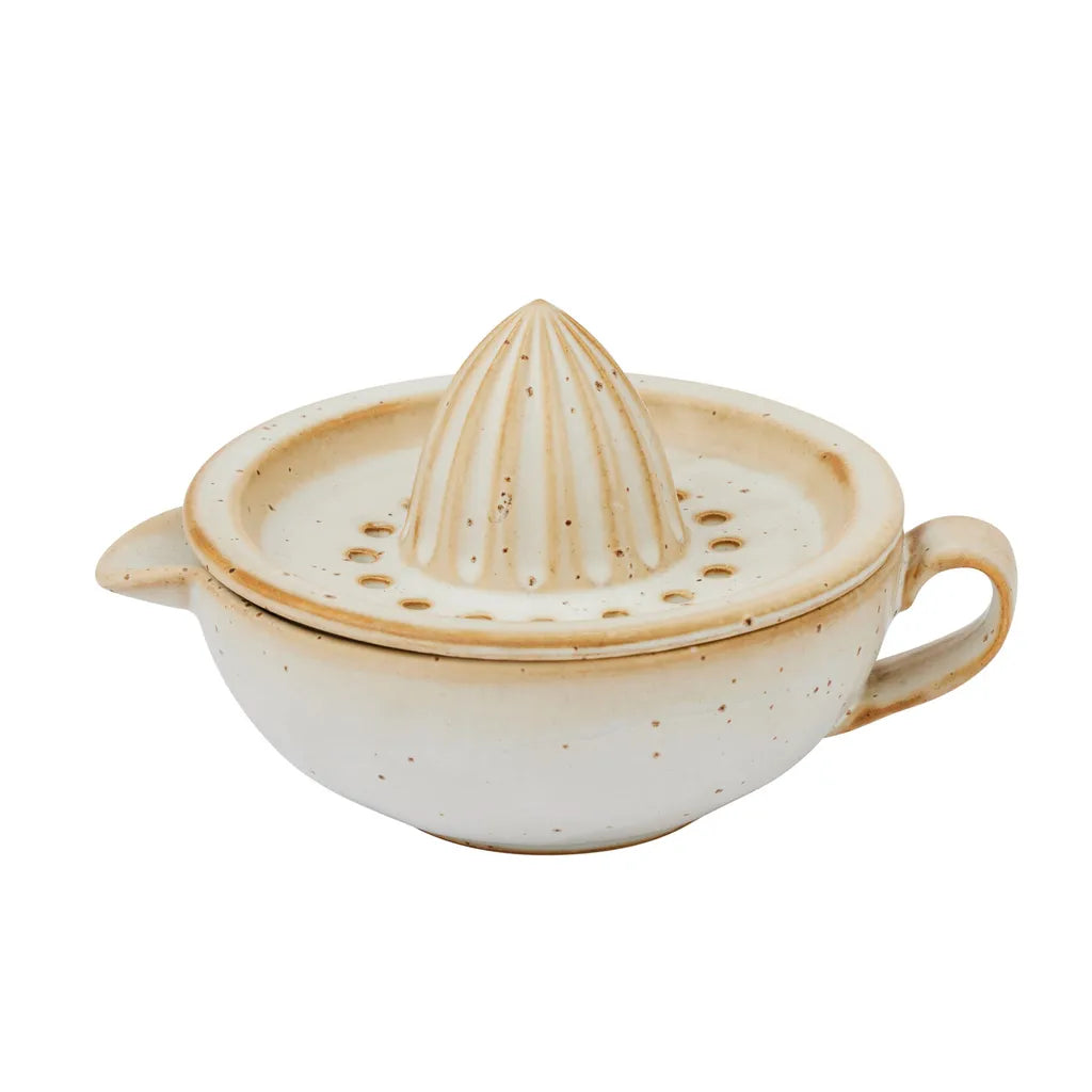 cream speckled ceramic material; two-piece design with reamer and bowl; bowl has handle and spout; rounded shape with textured reamer;