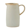 cream colour with brown speckled pattern; ceramic material; classic jug shape with handle; small pouring spout; matte finish;