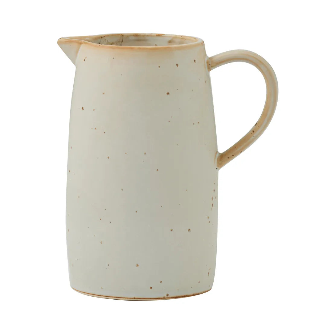 cream colour with brown speckled pattern; ceramic material; classic jug shape with handle; small pouring spout; matte finish;