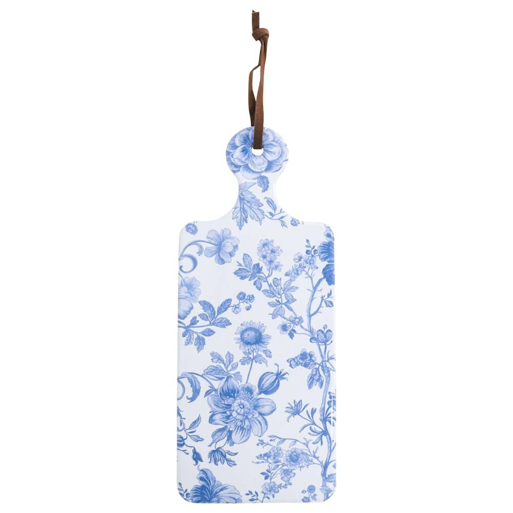 rectangular shape with rounded corners; blue floral pattern on white ceramic; small round handle with leather hanging loop; cork base visible on underside;
