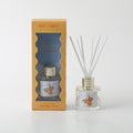 50ml clear glass bottle; cylindrical shape; gold coloured cap; label with oranges illustration; yellow and blue striped box packaging;