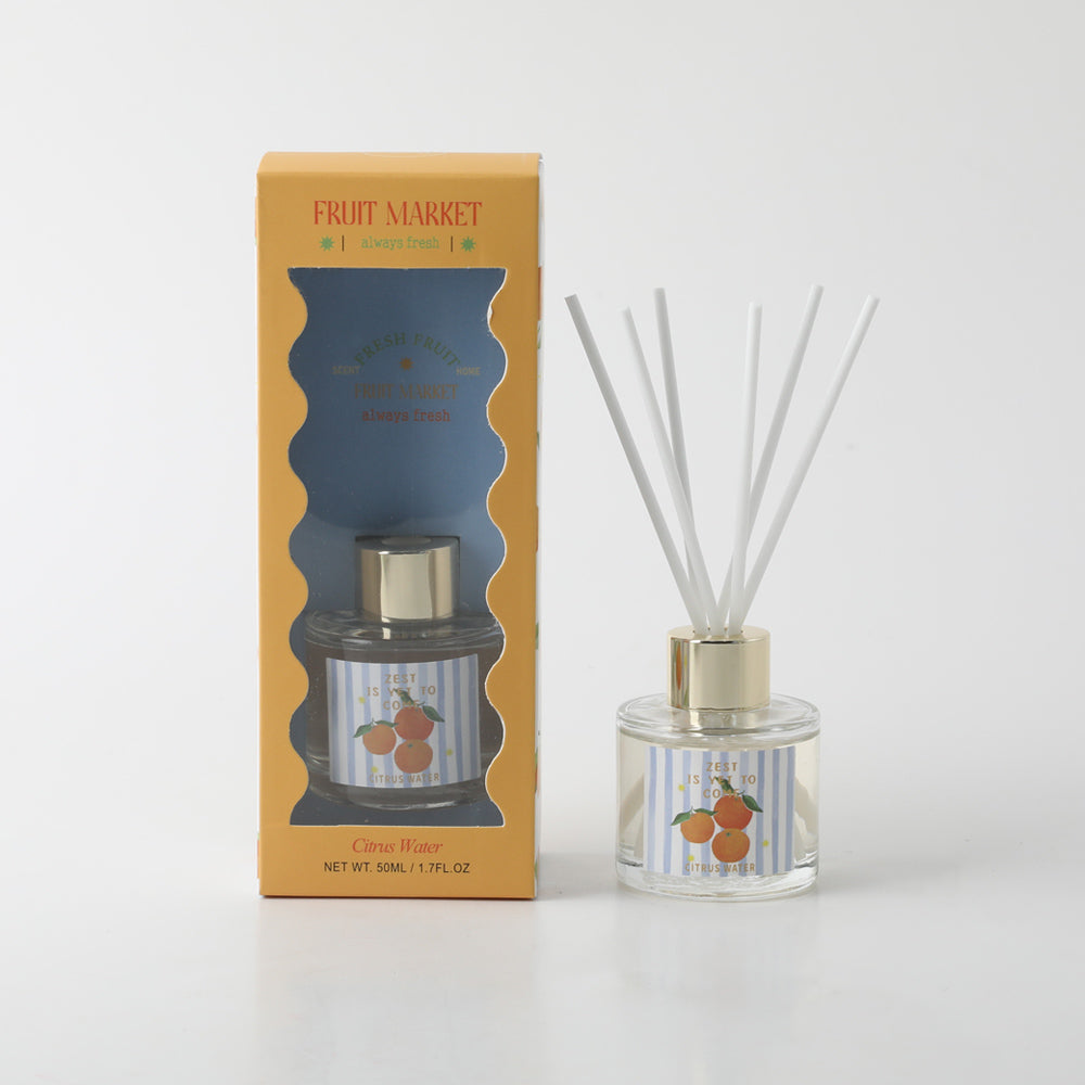50ml clear glass bottle; cylindrical shape; gold coloured cap; label with oranges illustration; yellow and blue striped box packaging;