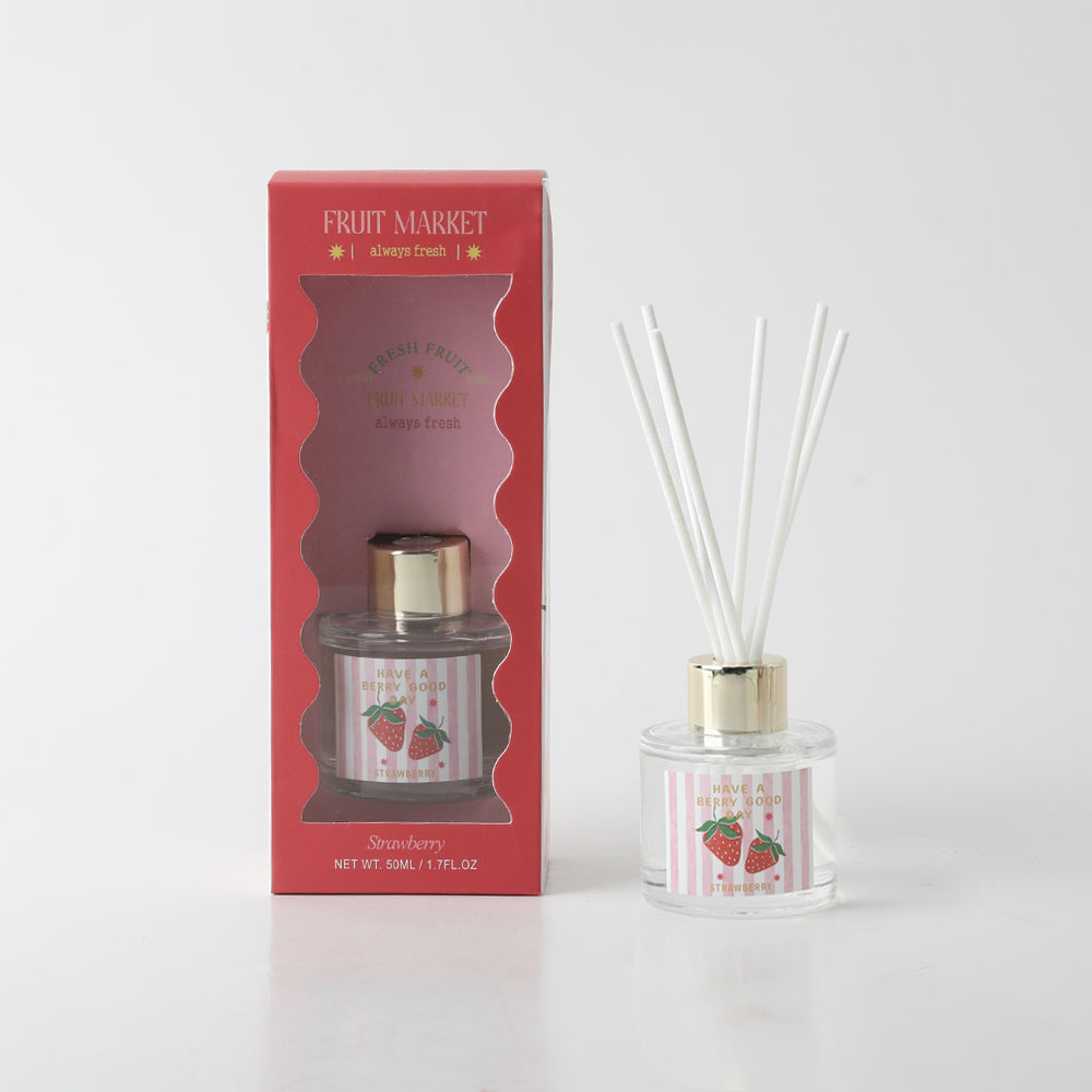 clear glass bottle with gold cap; red and white striped label with strawberry illustration; white diffuser reeds; red packaging box with window;