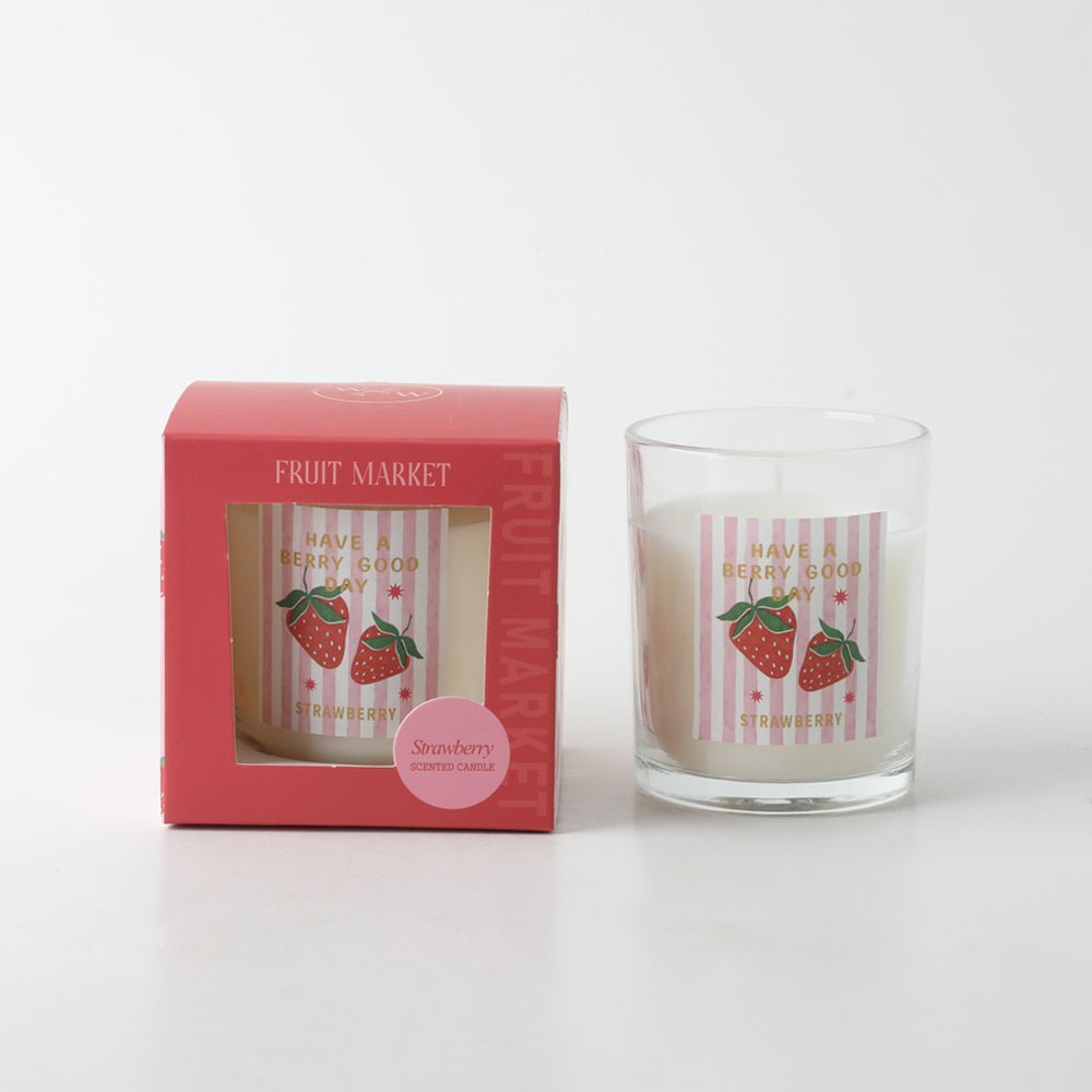 clear glass jar; white candle wax; pink and white striped label with strawberries; red packaging box; gold text on label;