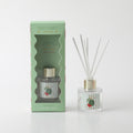 50ml clear glass bottle; gold-coloured cap; white diffuser reeds; light green packaging with watermelon graphics; label with watermelon image and vertical stripes;