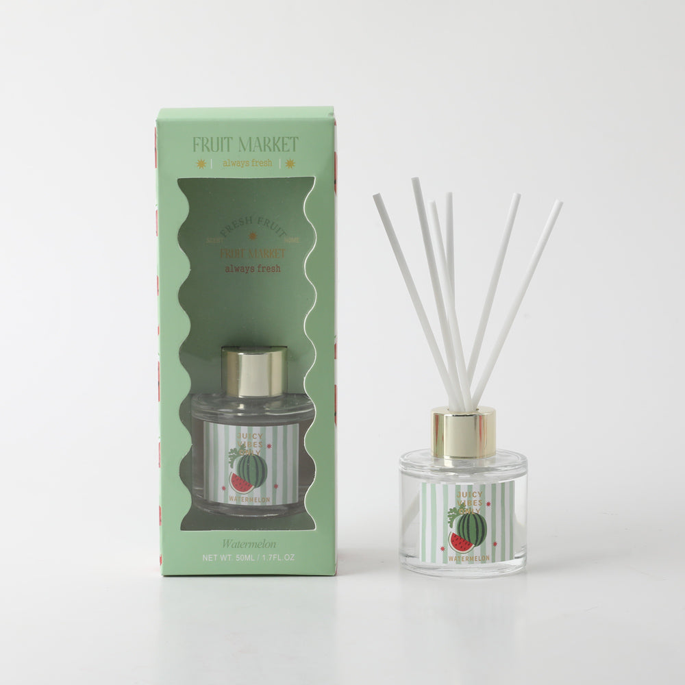 50ml clear glass bottle; gold-coloured cap; white diffuser reeds; light green packaging with watermelon graphics; label with watermelon image and vertical stripes;