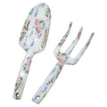 two garden tools including a shovel and a three-pronged rake; white enamel finish with pink and green floral pattern; metal material with glossy surface; handles have holes for hanging;
