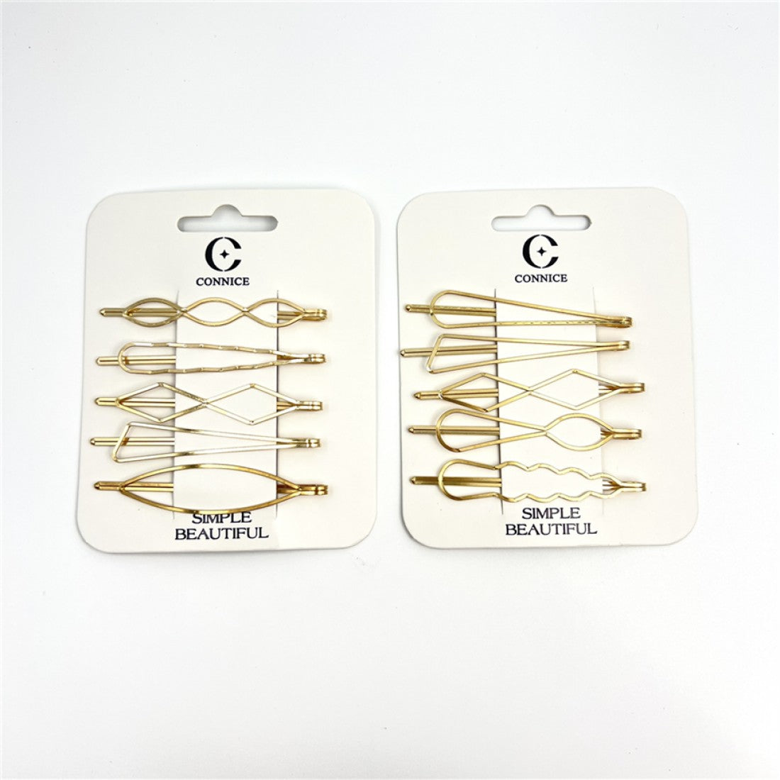 Gold-tone metal hair clips; Geometric shapes including loops and zigzags; Packaged on white backing cards; Each card printed with the brand name "CONNICE" and text "SIMPLE BEAUTIFUL";