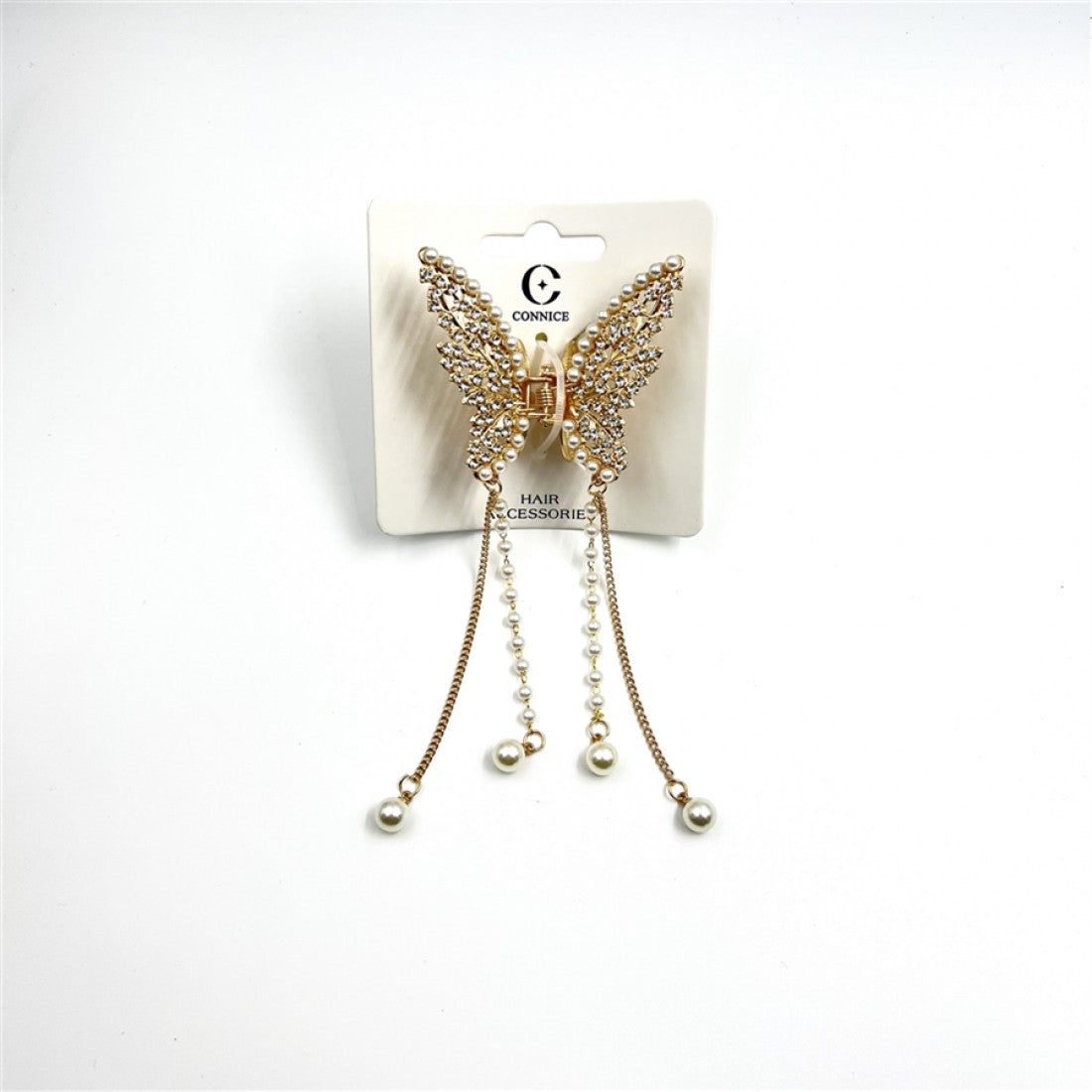 Gold-toned butterfly-shaped claw clip; Wings decorated with small clear rhinestones; Long dangling chains with faux pearls; Mounted on branded hair accessory card packaging;