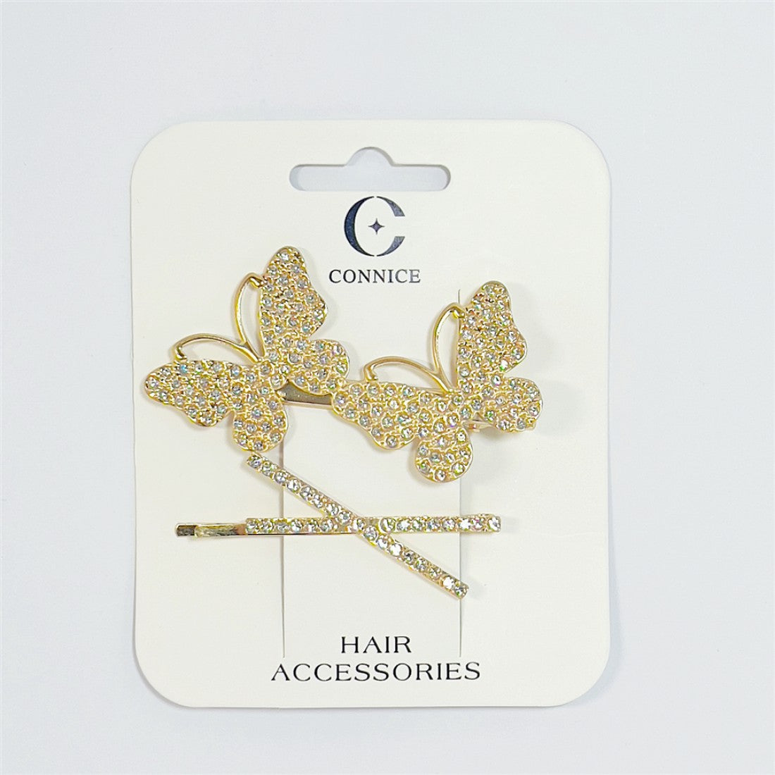Set of two gold-tone hair clips; Large butterfly shapes covered in clear rhinestones; Straight bar clip with matching rhinestones; Mounted on branded white backing card labelled hair accessories;