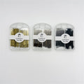 Three clear plastic cases shown side by side; Pins in metallic gold, bronze and black tones; Front label reads "CONNICE Non-Slip"; Compact case with rounded top and hanging hole;