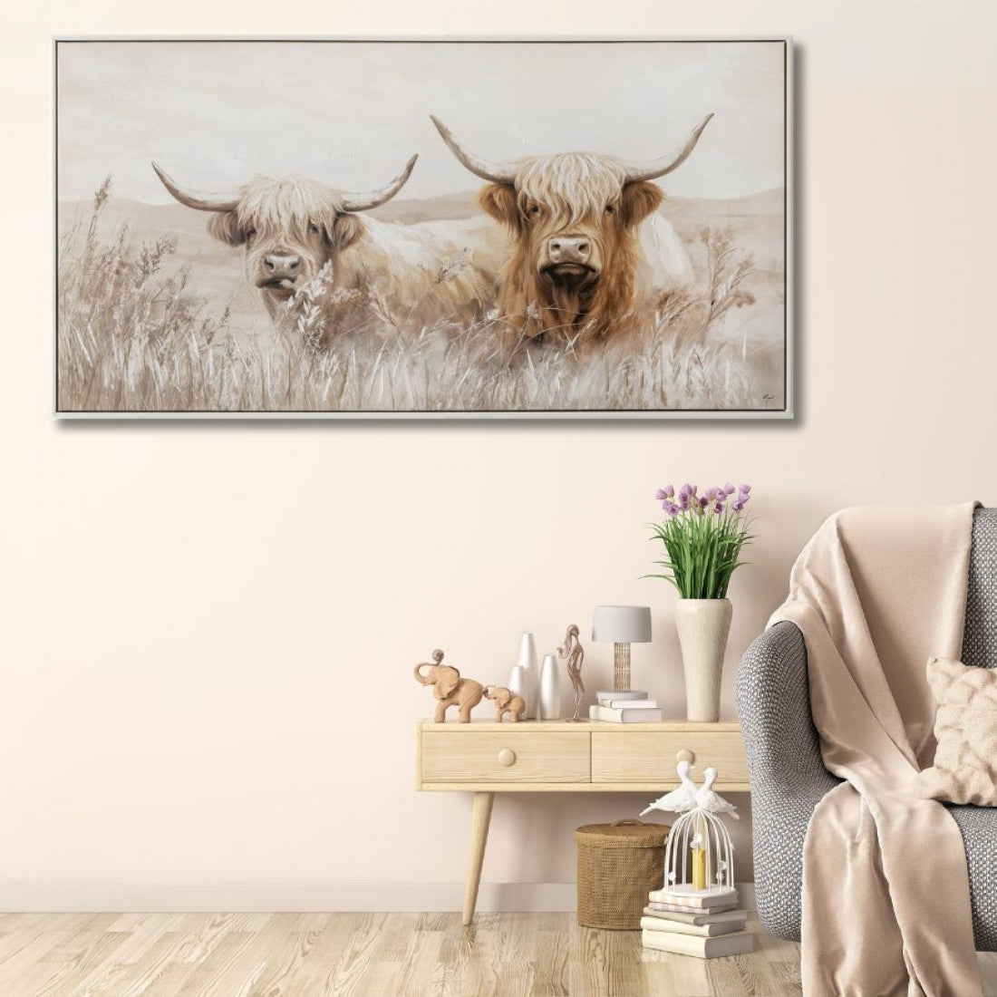 Rectangular canvas with cream and brown tones; Image of two highland cows in natural setting; Slim, light-coloured frame; Canvas texture visible on surface;