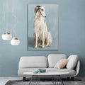 Framed canvas print; Light grey and beige dog on blue background; Rectangular shape; Muted colour palette; Thin gold frame;