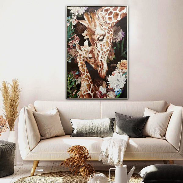 Vertical rectangular print; Depicts two giraffes; Floral background; Framed artwork; Natural brown and cream colours;