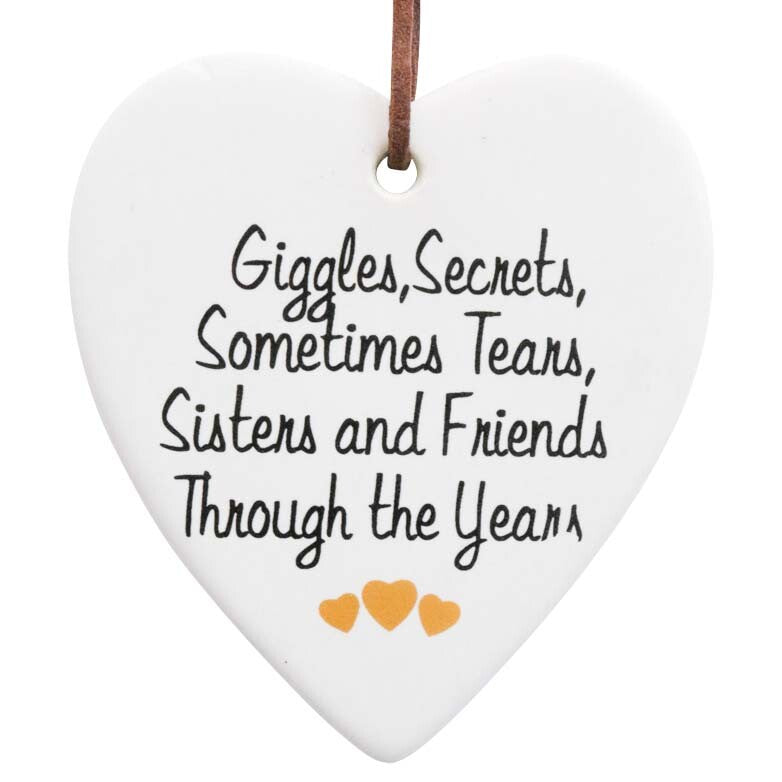 white ceramic heart shape; black script text; three small orange hearts; brown faux-leather hanging cord; matte finish surface;