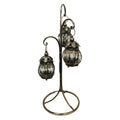 Three rounded glass lanterns hanging at different heights; Ornate antique-style metal detailing on lantern tops and frames; Tall curved metal stand with circular open base; Dark metallic finish with a slightly aged look;