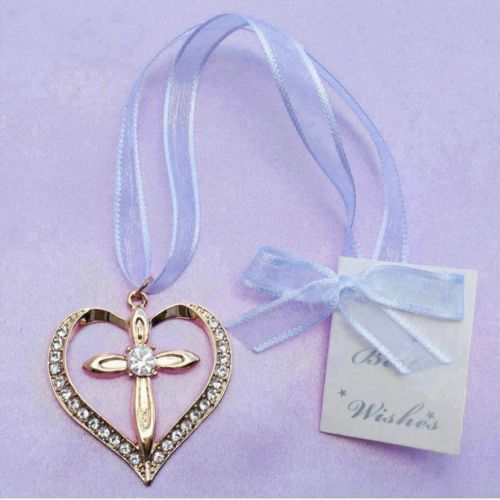 gold-tone heart shape with cross; ring of clear crystals in heart outline; pale sheer ribbon attached; small tag with blue bow;