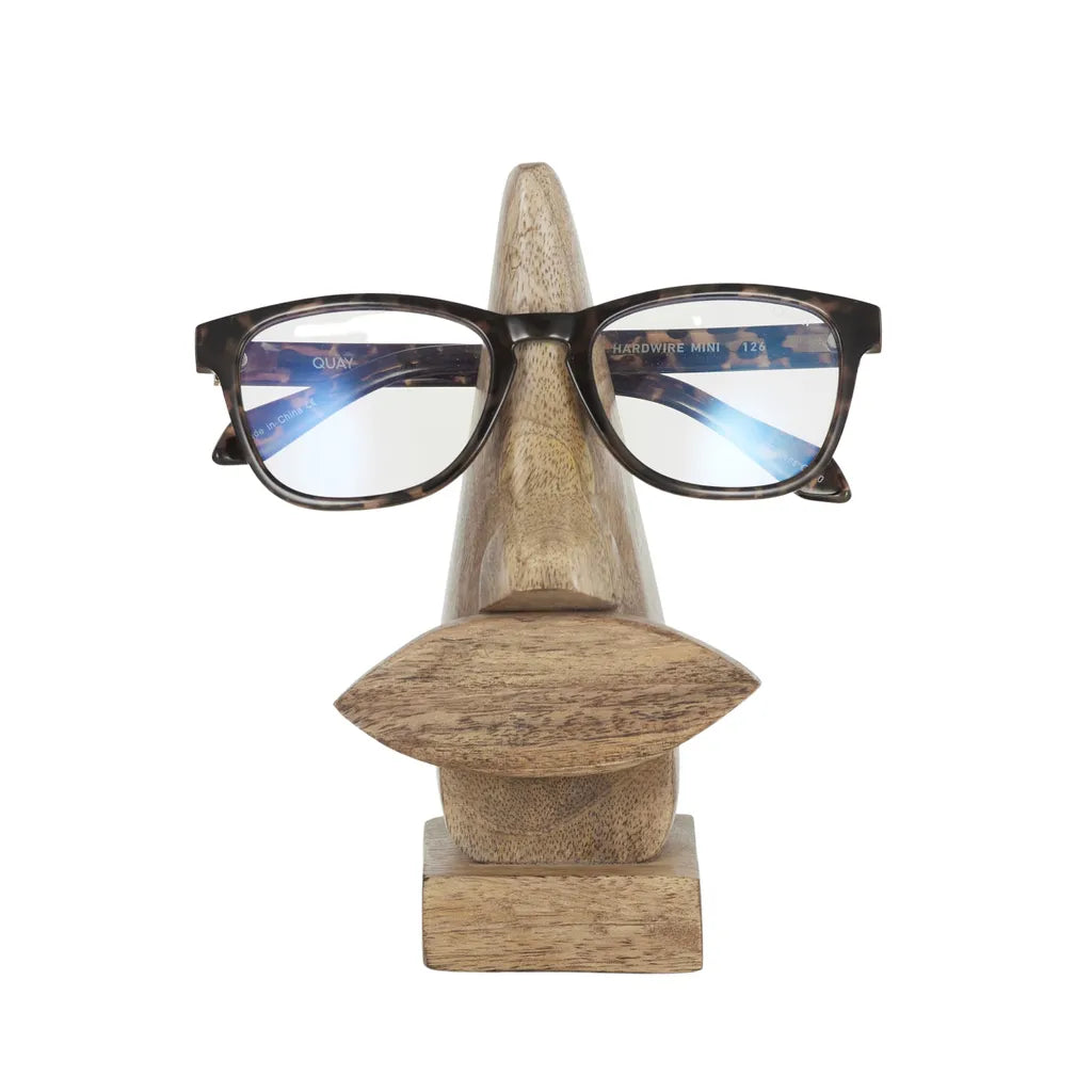 natural light wood colour; wood grain texture visible; sculpted shape resembling nose and lips; compact rectangular base; smooth polished finish;