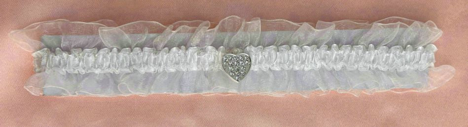 Ivory colour; Ruffled sheer fabric; Small heart-shaped rhinestone charm; Elasticated band;