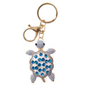 blue turtle shape; rhinestone shell; gold metal edges; lobster clasp and keyring attachment; metallic shimmer finish;