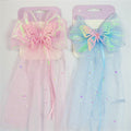 Large iridescent bow with layered organza look; Glitter butterfly motif at the centre of the bow; Long tulle-style veil with star and moon confetti; Pastel pink version and pastel blue version shown on display cards;