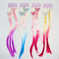 Butterfly-shaped clips with glitter finish; Attached long straight hair extensions; Mixed bright and pastel colours including pink, blue, purple, yellow and red; Packaged on pale purple backing cards labelled kids accessories;