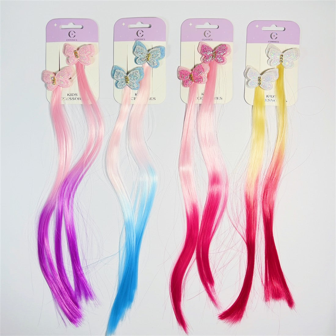 Butterfly-shaped clips with glitter finish; Attached long straight hair extensions; Mixed bright and pastel colours including pink, blue, purple, yellow and red; Packaged on pale purple backing cards labelled kids accessories;