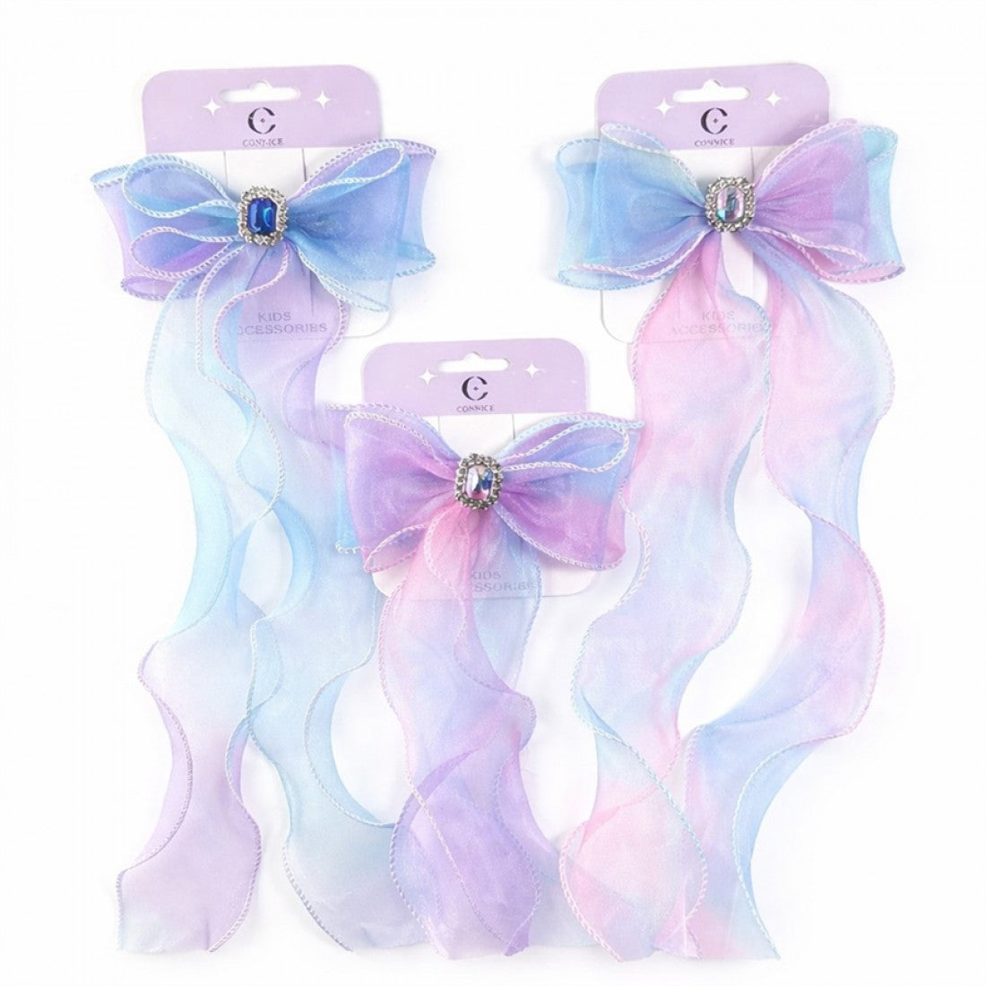 Sheer organza bow in pastel blue and pink; Long wavy ribbon tails with stitched edges; Oval rhinestone centre with faceted stone; Mounted on light purple display card with stars;