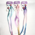 Clip-in hair extensions on backing cards; Rainbow pastel colours including blue, pink, purple and yellow; Fruit-shaped charms such as peach and strawberry; Braided strands mixed with straight synthetic hair;
