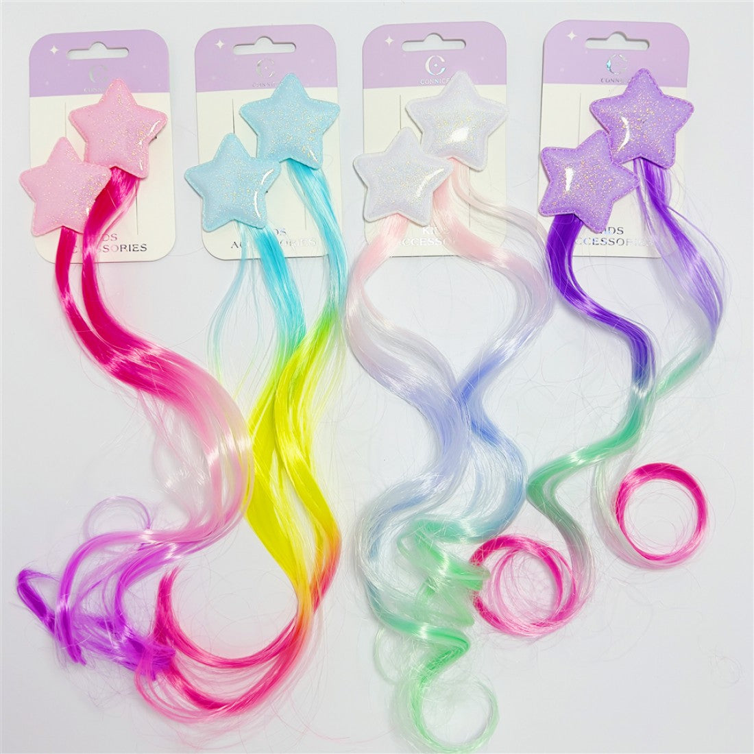 Glittery star-shaped hair clips; Attached long wavy synthetic hair strands; Bright mixed colours including pink, blue, yellow, green and purple; Mounted on pastel purple and white backing cards;