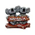 two grey koalas; brown wood-like sign with 'AUSTRALIA' text; resin material; smiling koalas; compact size;