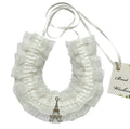 white lace with ruffled edges; silver Eiffel Tower charm pendant; thin white ribbon tie; delicate, lightweight design;
