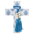 blue and white patterned cross shape; bold blue rope wrapped at top; six large white wooden beads on rope; blue tassels hanging from beads; cross dimensions approximately 16x22cm;
