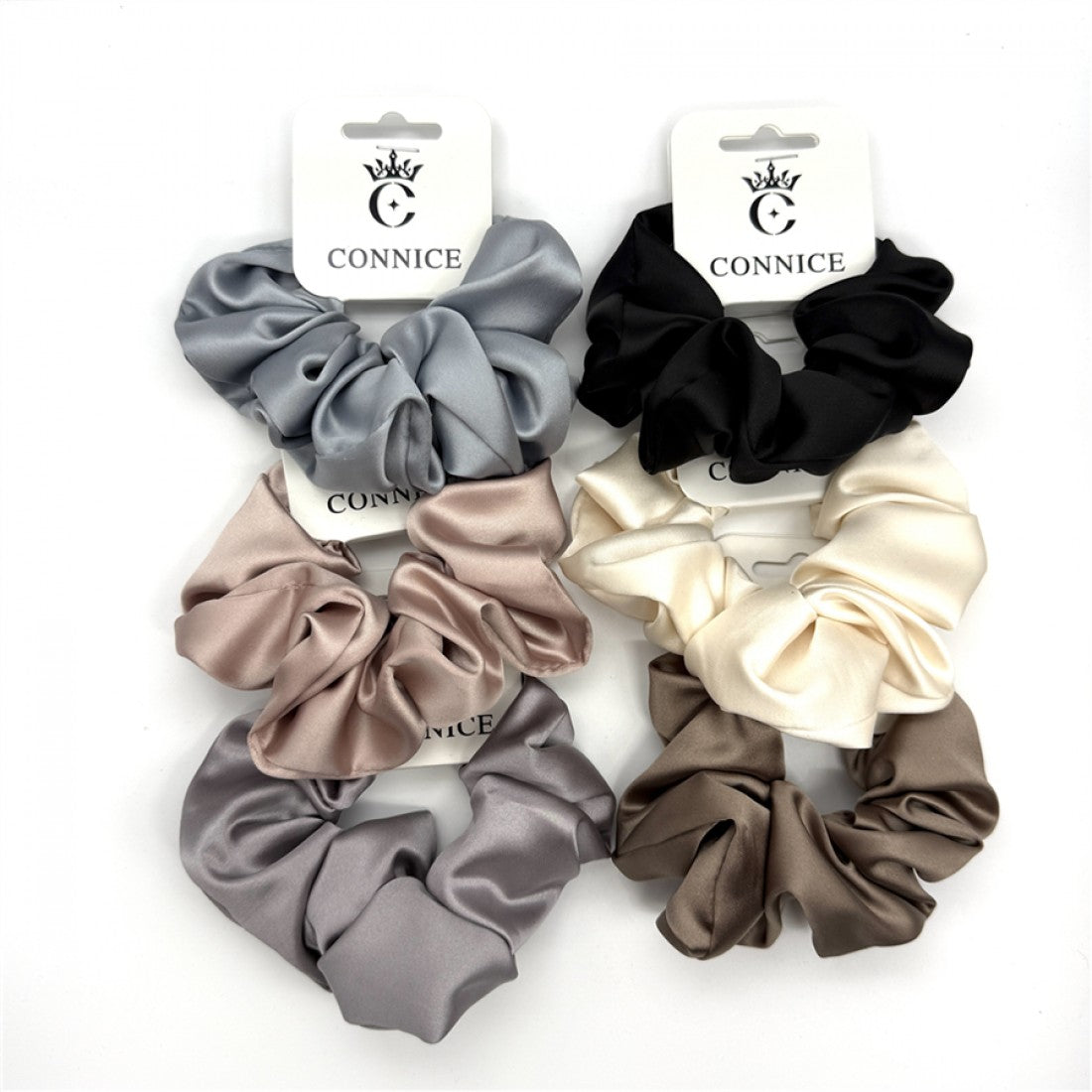 Large, gathered scrunchie design; Smooth satin-like fabric with sheen; Neutral colours including grey, black, cream and taupe; Carded packaging branded "CONNICE";