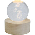 clear spherical glass ball; etched jellyfish design; glowing moon and stars; natural wood round base; soft white LED light;