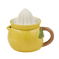 yellow ceramic body shaped like a lemon; white ceramic ridged reamer on top; brown handle attached; small spout for pouring; green leaf detail;