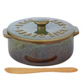 Olive green ceramic finish; Round shape with two side handles; Includes matching ceramic lid with knob; Comes with wooden spreader;