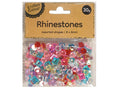 clear plastic zip-lock bag packaging; brown cardboard label with black text; assorted rhinestone shapes including round, square, heart; multicoloured stones in pink, red, blue, yellow and clear;