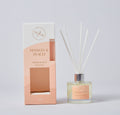 50ml clear glass bottle; light yellow diffuser liquid; white reed sticks inserted; peach and white colour box packaging; silver collar on bottle neck;